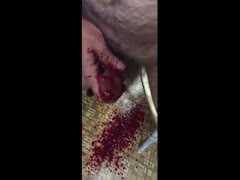 Masochist man making his dick bleed before cutting it off